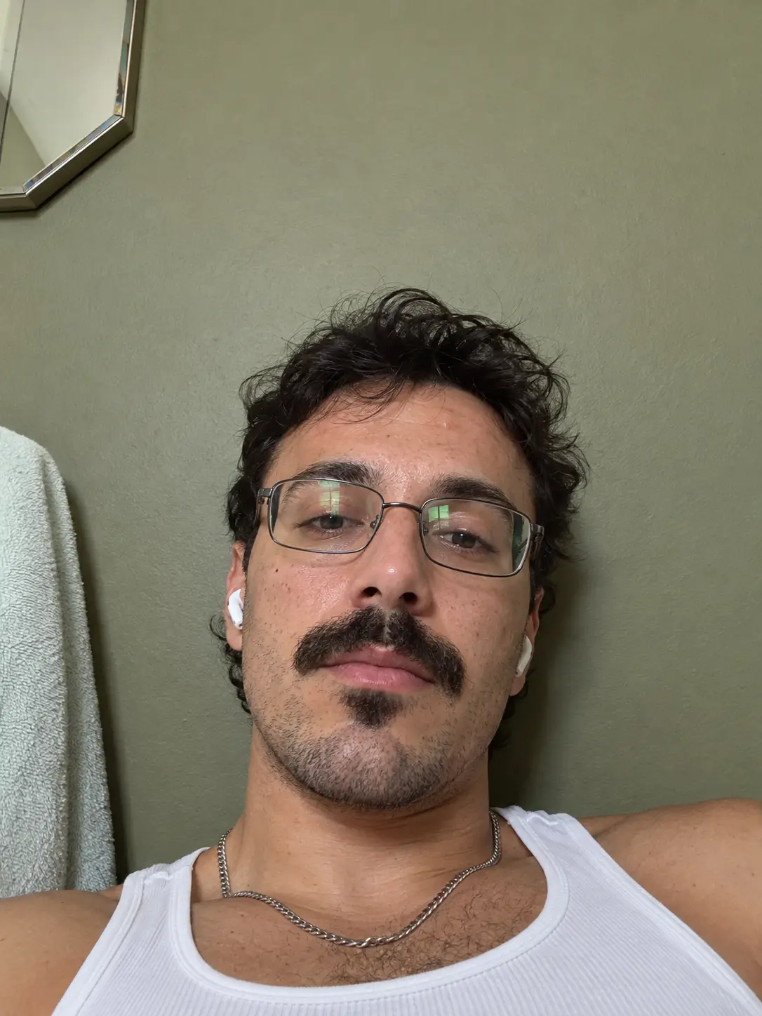 Young man with glasses and mustache realistic selfie